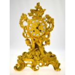 A 19th century French Rococo Revival ormolu mantel clock of profusely scrolling design,