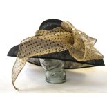 A Philip Somerville swirled net hat embellished with red silk leaves,