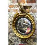A Regency style carved giltwood convex mirror,