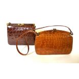 Two Art Deco crocodile handbags, another later crocodile handbag and a later tooled leather handbag,