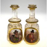 A pair of 19th century Continental glass decanters with enamelled and gilded foliate decoration and