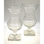 A pair of heavy cut crystal vases raised on star-cut square bases, 37.