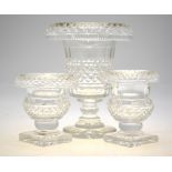 A pair of heavy cut glass posy vases with fold-over rims raised on square star-cut bases, 12.8 cm h.