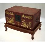 A Chinese red painted leather covered travelling box decorated with gilded phoenix and foliage,
