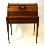 A 19th century continental marquetry inlaid cylinder desk having a marble and gilt metal gallery