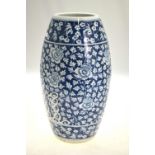 A Chinese blue and white slim barrel shaped vase decorated with peony, flowers,