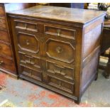 A 17th century jointed oak chest having an irregular arrangement of four long drawers with applied