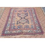 An antique Shiraz rug, 1st half 20th century, the pale red ground with twin diamond design,