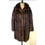 A dark brown musquash fur coat retailed by Harrods,
