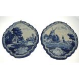 A pair of Dutch Delft blue and white shaped plaques decorated with rural canal scenes with figures,