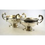 A late Victorian pair of Asprey silver rose bowls with scroll handles, on stemmed foot-rims,