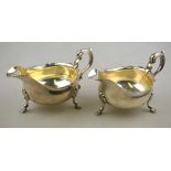 A pair of Edwardian heavy quality silver sauce-boats in the Georgian manner, with shaped rims,