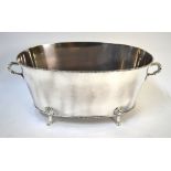 A large oval electroplated champagne bath with twin loop handles and paw feet,