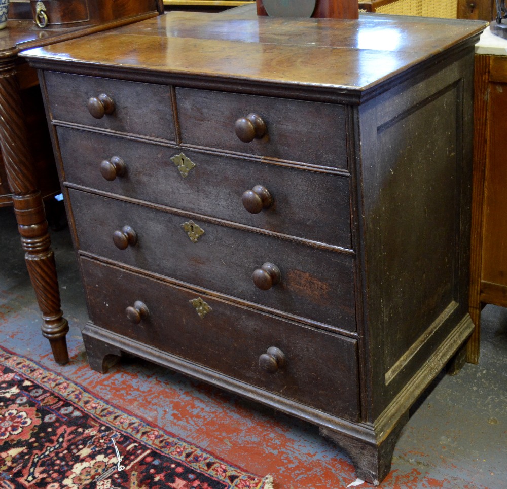 An 18th century oak chest of two short over three long graduated drawers raised on bracket feet,