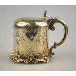 A Victorian silver mustard with hinged domed lid, scroll handle and cast feet,