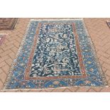 An old Kurdish rug, the stylised floral design on blue ground, 1.76 x 1.