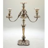 A plated on copper twin-branch candelabra with three sconces and foliate-embossed decoration,