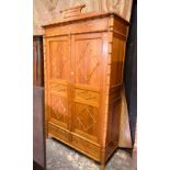 An unusual Continental pine and faux bamboo armoire with pair of doors over a pair of drawers,