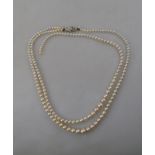 A two-row graduated cultured pearl necklace, on 9ct snap set with rose diamond,