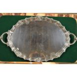 A heavy quality oval silver tray with gadrooned pie-crust rim and twin handles cast with ram's