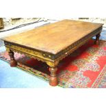 An iron bound plank top hardwood coffee table of eastern origin,