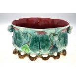 A Continental majolica oval planter moulded in the form of lily pads and flowers,