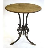 A late 19th century Coalbrookdale style cast iron tripod table with circular wooden top,