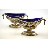 A pair of late Victorian Adam Revival pierced silver salts of navette form with ring handles and