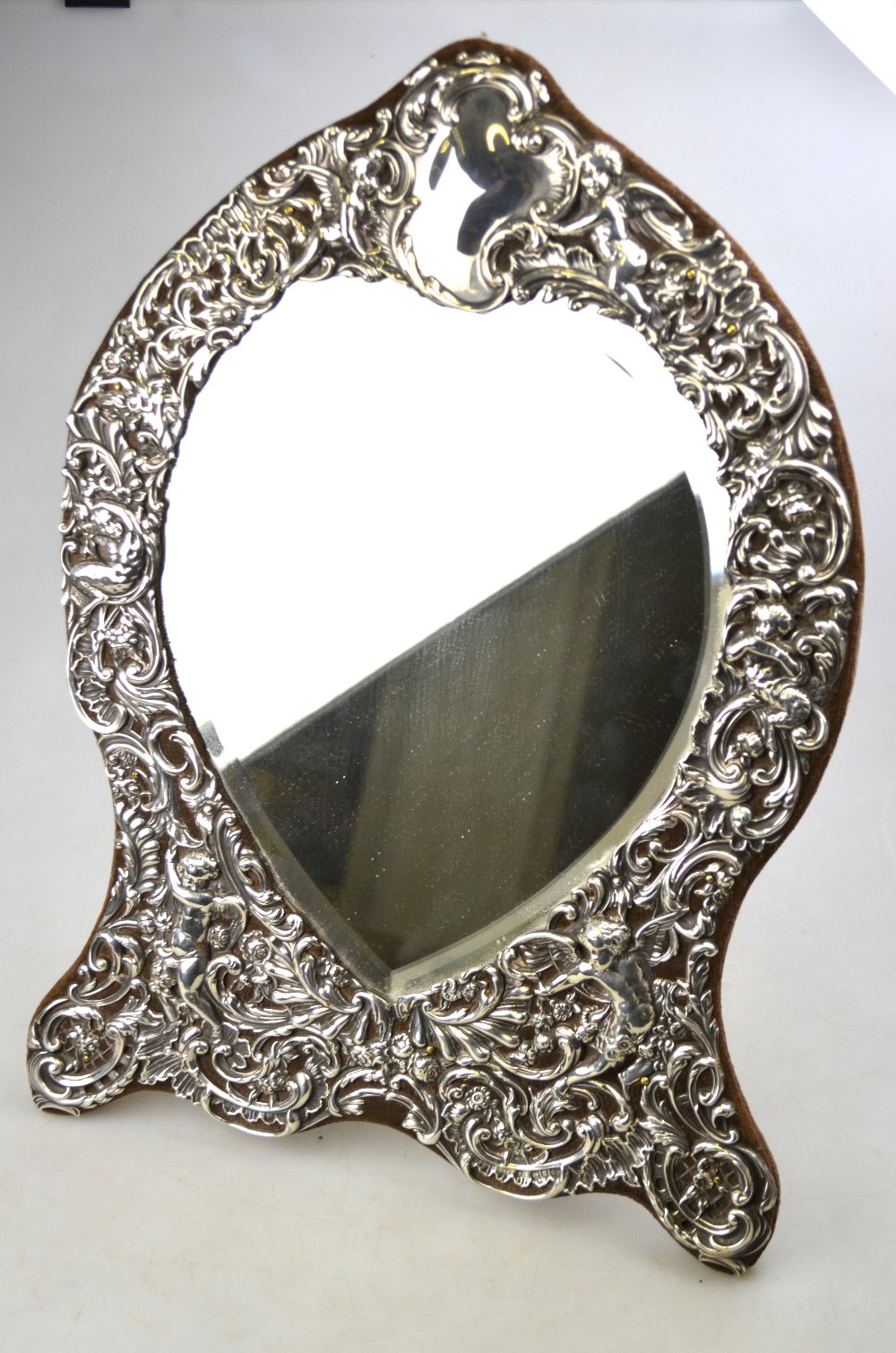 A large Victorian silver-faced easel toilet mirror with heart-shaped bevelled plate surmounted by