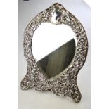 A large Victorian silver-faced easel toilet mirror with heart-shaped bevelled plate surmounted by