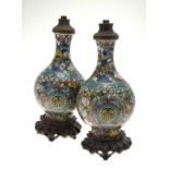 A pair of 19th century Chinese cloisonne ovoid vases with flare necks decorated with roundels of