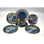 A Chinese blue and white saucer dish decorated to the centre with a dragon amongst waves,