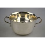 An Edwardian silver sugar basin in the form of a porringer with twin scroll handles, S. W.