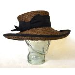 A Bronte mocha and black straw effect hat, a purple woven straw hat,