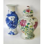 A Chinese blue and white slim baluster vase with flared neck decorated with figures on a terrace,