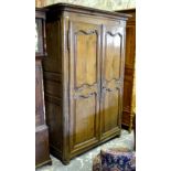 A late 17th/18th century French provincial jointed oak armoire,