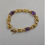 A yellow and red gold fancy linked bracelet set with three cabochon amethysts,