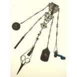 A Victorian electroplated chatelaine, hung with a tape measure, ivory-leaf notebook,