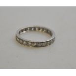 A full eternity ring set with brilliant cut diamonds, engraved sides,