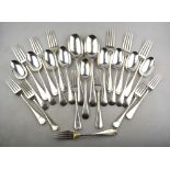 A part set of silver OEP flatware comprising nine dessert spoons, seven dessert forks,