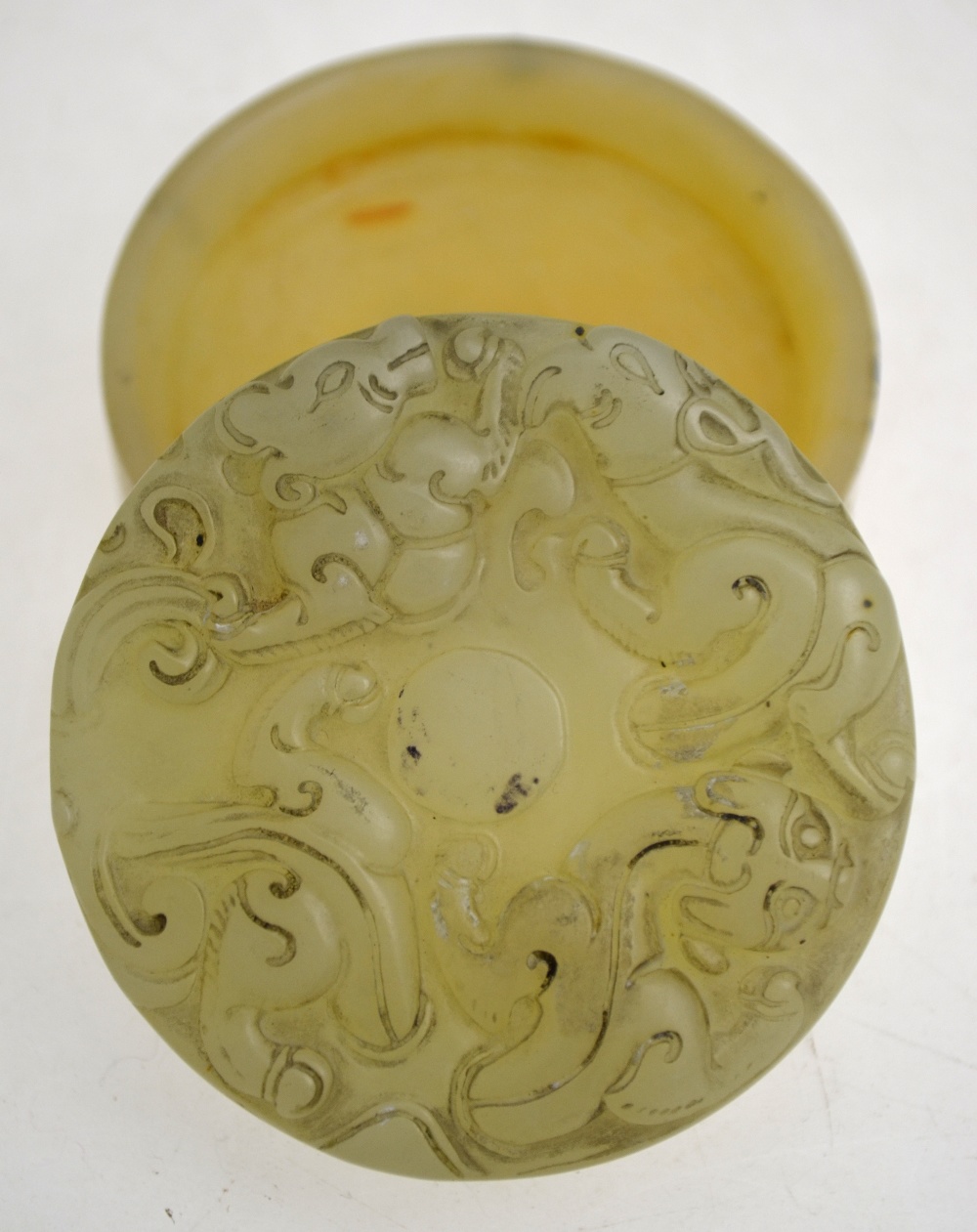 A Chinese oval pale jade plaque carved in shallow relief with auspicious objects (11. - Image 5 of 6