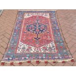 An old Persian Hamadan rug, the blue centre medallion on rust ground, 1.80 x 1.