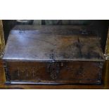 A 16th century oak slope top box having a hinged top over a plank front scratch carved 'MB 1736',