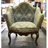 A 19th century hump backed upholstered armchair,