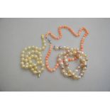 A row of pale and slightly graduated coral beads on silver snap,