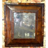 A William & Mary oyster veneered deep cushion framed wall mirror retaining original bevel edged