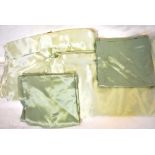 A pair of vintage pale green heavy satin bed covers with pair of darker green pillowcases,