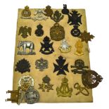 A quantity of assorted British military cap badges including 9th Lancers; Connaught Rangers;