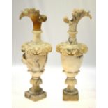 A pair of alabaster garniture urns with floral and foliate carved decoration,