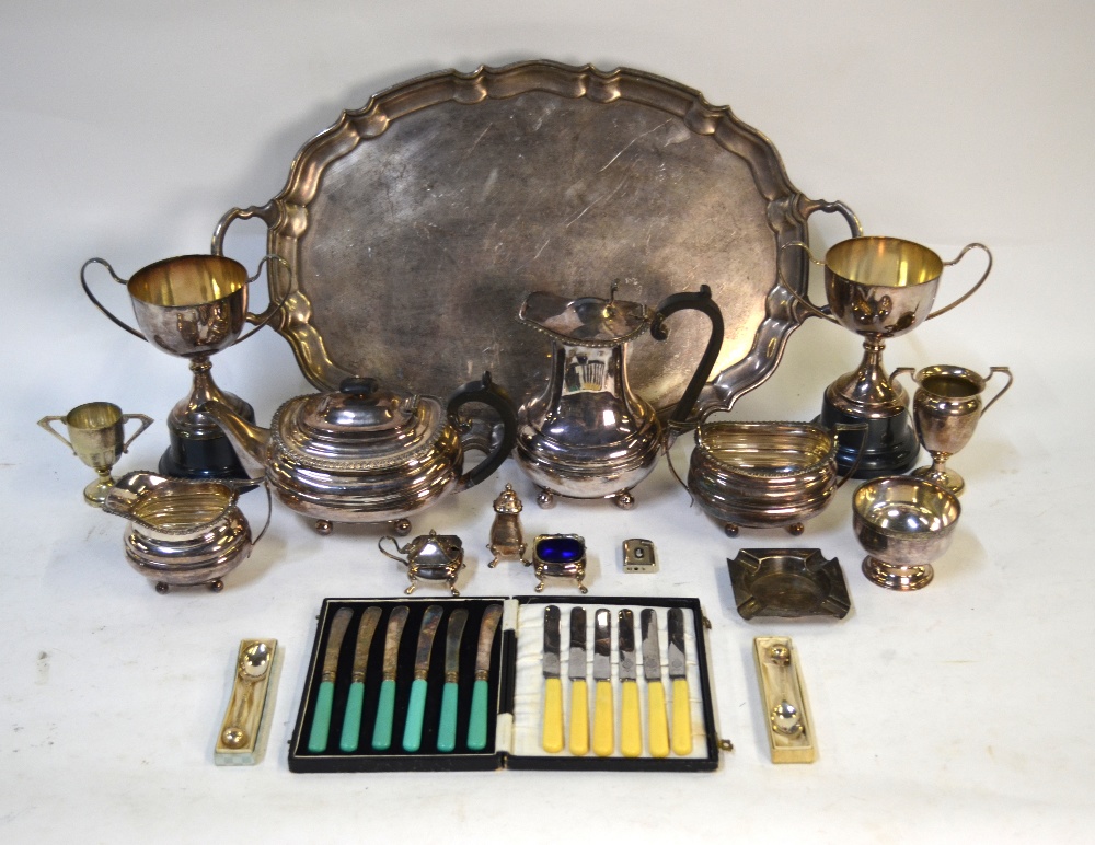 An electroplated oval tray, four-piece tea service, trophy cups, etc.